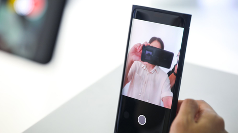 When taking a selfie, hiding that part of the screen, the camera turns to black to improve image quality.